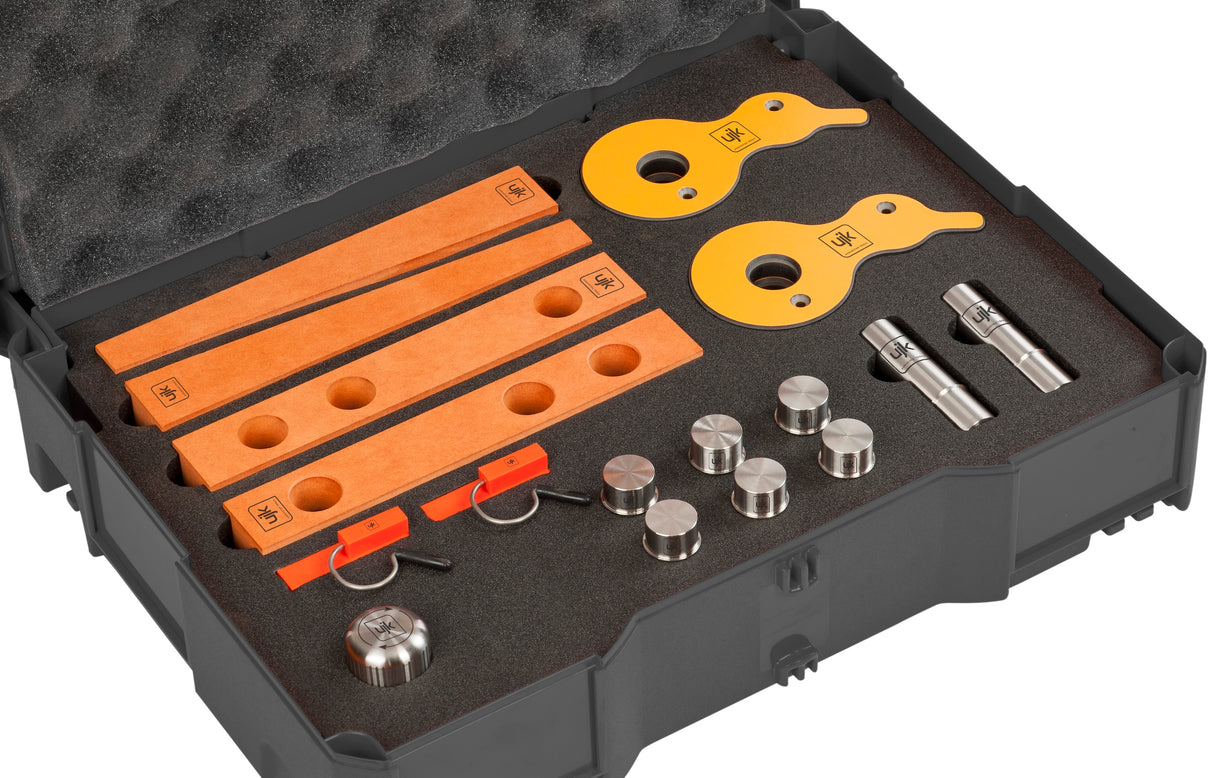 UJK work holding accessory kit components including cam clamps, wedges, back stops, guide pups and dogs in T-Loc case
