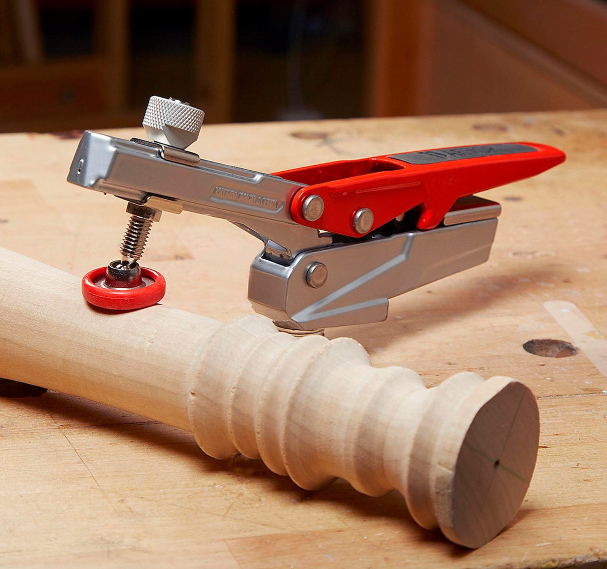 Armor Tool Auto-PRO Bench Dog Hold-Down Clamp in action on woodworking bench
