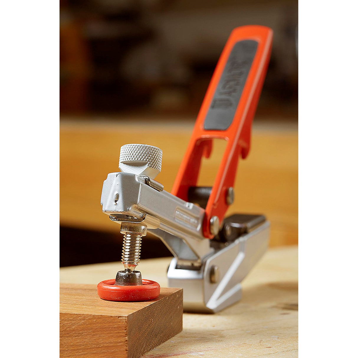 Armor Tool Auto-PRO Bench Dog Hold-Down Clamp in use on woodworking bench with horizontal toggle clamp mechanism