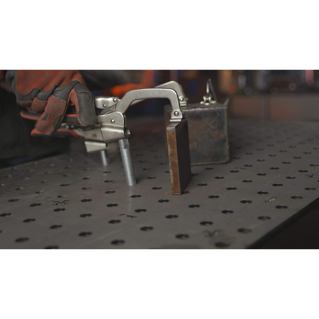 Armor Tool Auto-PRO Hold Down Clamp 76mm in use on workbench - automatic technology adjusts grip for different objects efficiently