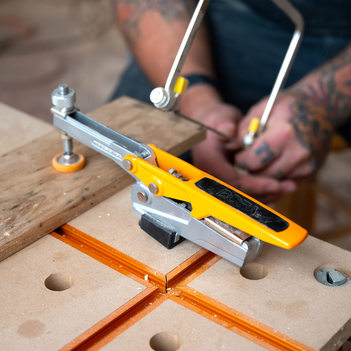 BORA Tool Dog Hole Auto Adjust Horizontal Toggle Clamp in use on workbench