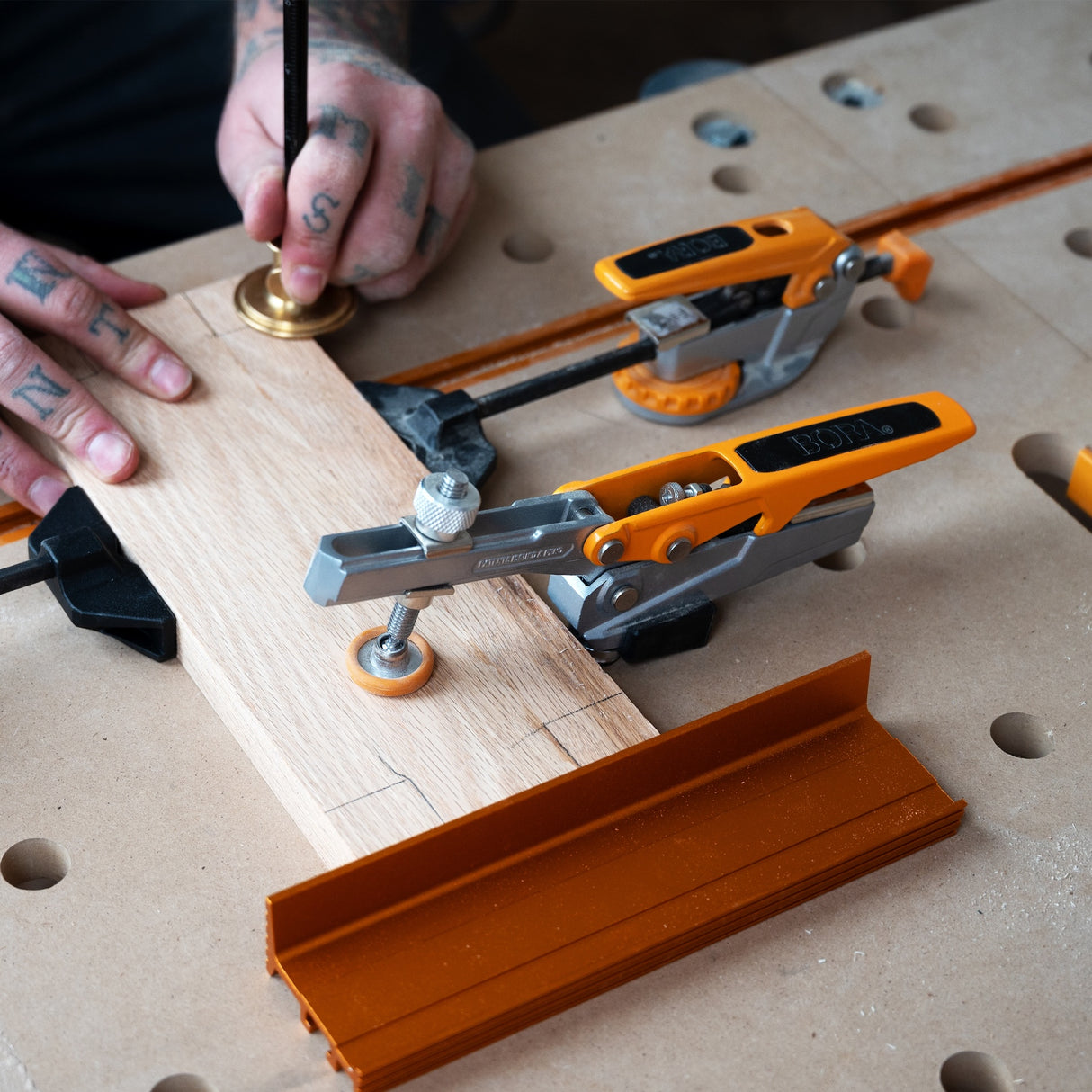 BORA Tool Dog Hole Auto Adjust Toggle Clamp in action with 19mm bench dog post securely gripping into hole