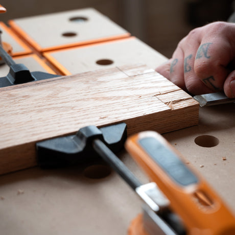 Australian-made BORA Tool Dog Hole Auto Adjust Inline Toggle Clamp in use on workbench