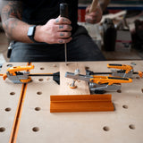 BORA Tool Dog Hole Auto Adjust Inline Clamp in action on workbench