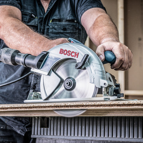 Person using a Bosch circular saw to cut wood.
