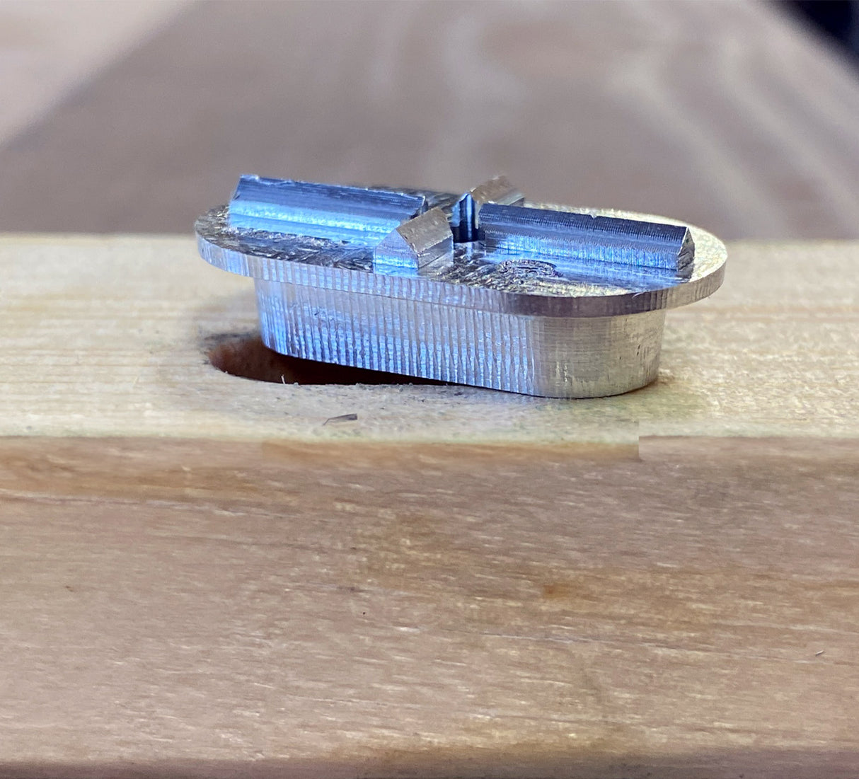 FastCap metal Mortise Marker sitting above mortise in timber