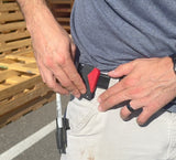 Person with a belt attaching the FastCap tape measure lock 