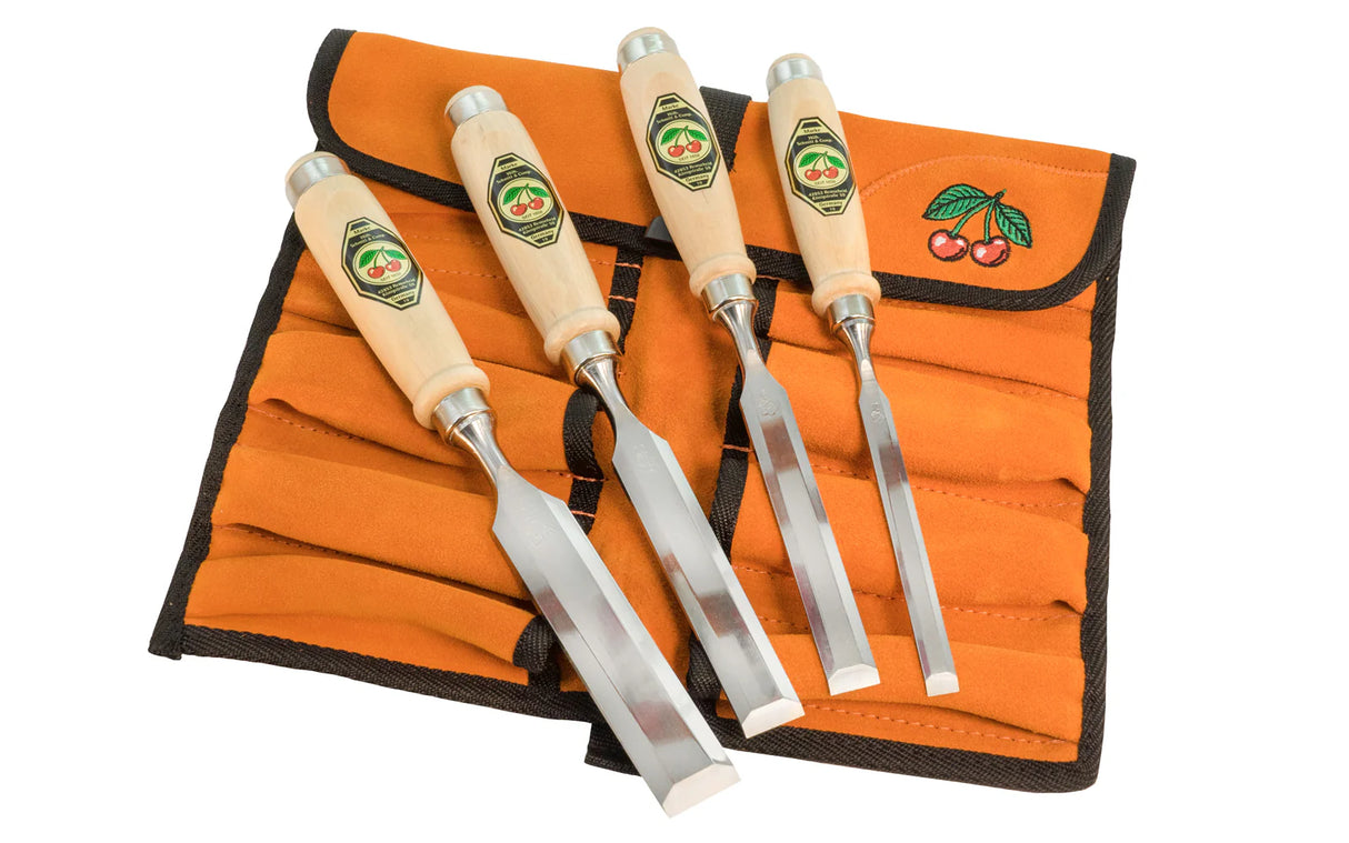 Set of four chisels on an orange tool roll with a white background
