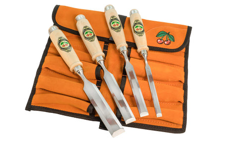 Set of four chisels on an orange tool roll with a white background