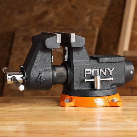 Pony bench vice on a wooden surface with a blurred background