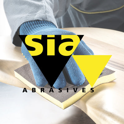 Person wearing blue gloves using a sanding sponge with Sia Abrasives logo.